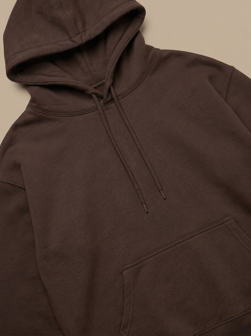 Brown hoodie on a beige background