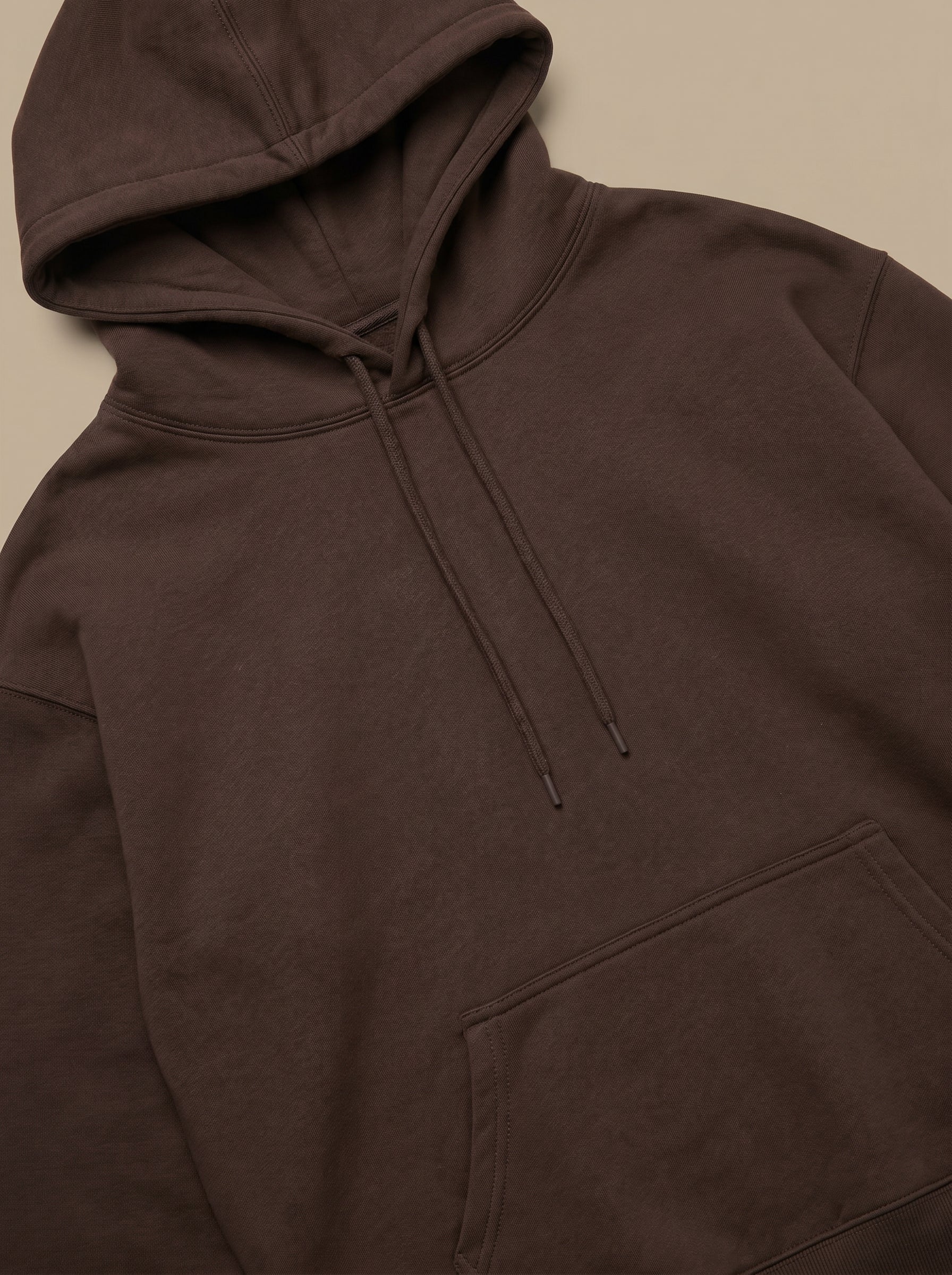 Brown hoodie on a beige background