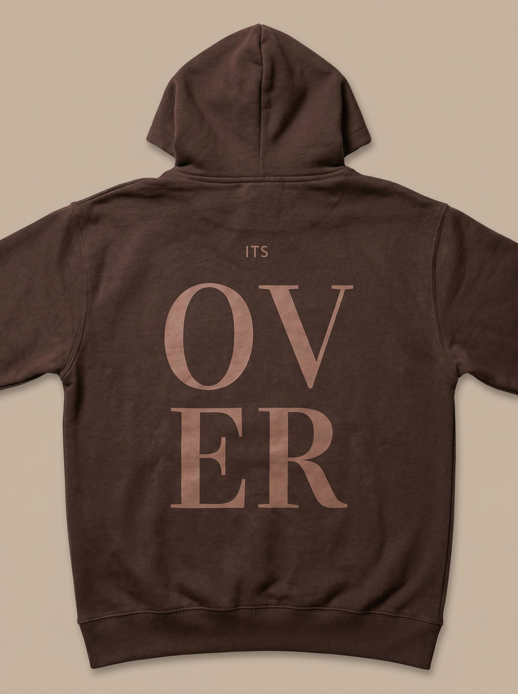 Brown hoodie with 'ITS OVER' text on the back against a beige background