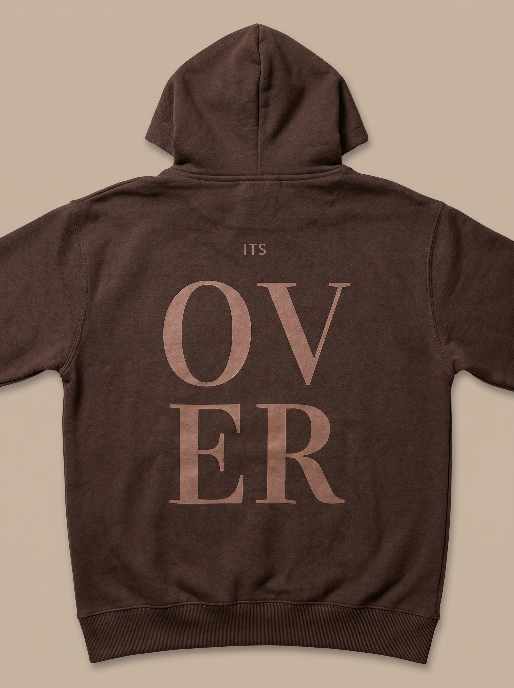 Brown hoodie with 'ITS OVER' text on the back against a beige background