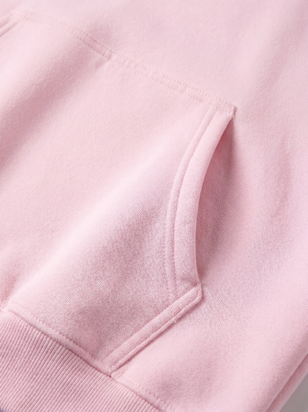 Close-up of a pink hoodie with a pocket detail
