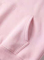 Close-up of a pink hoodie with a pocket detail