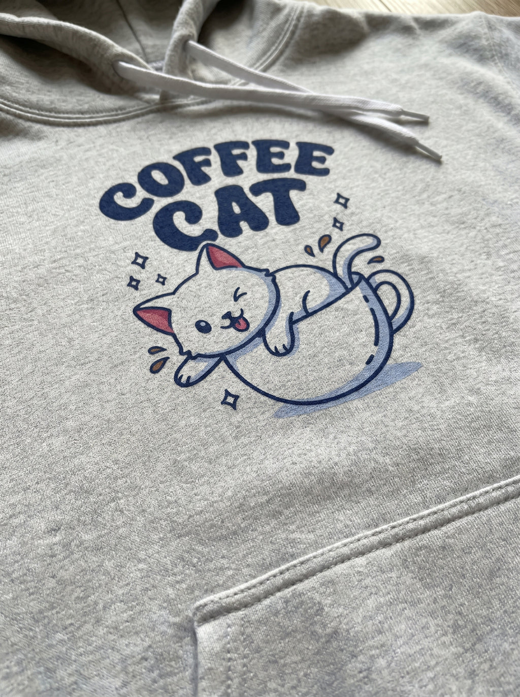 Gray hoodie with 'Coffee Cat' graphic design on a plain background