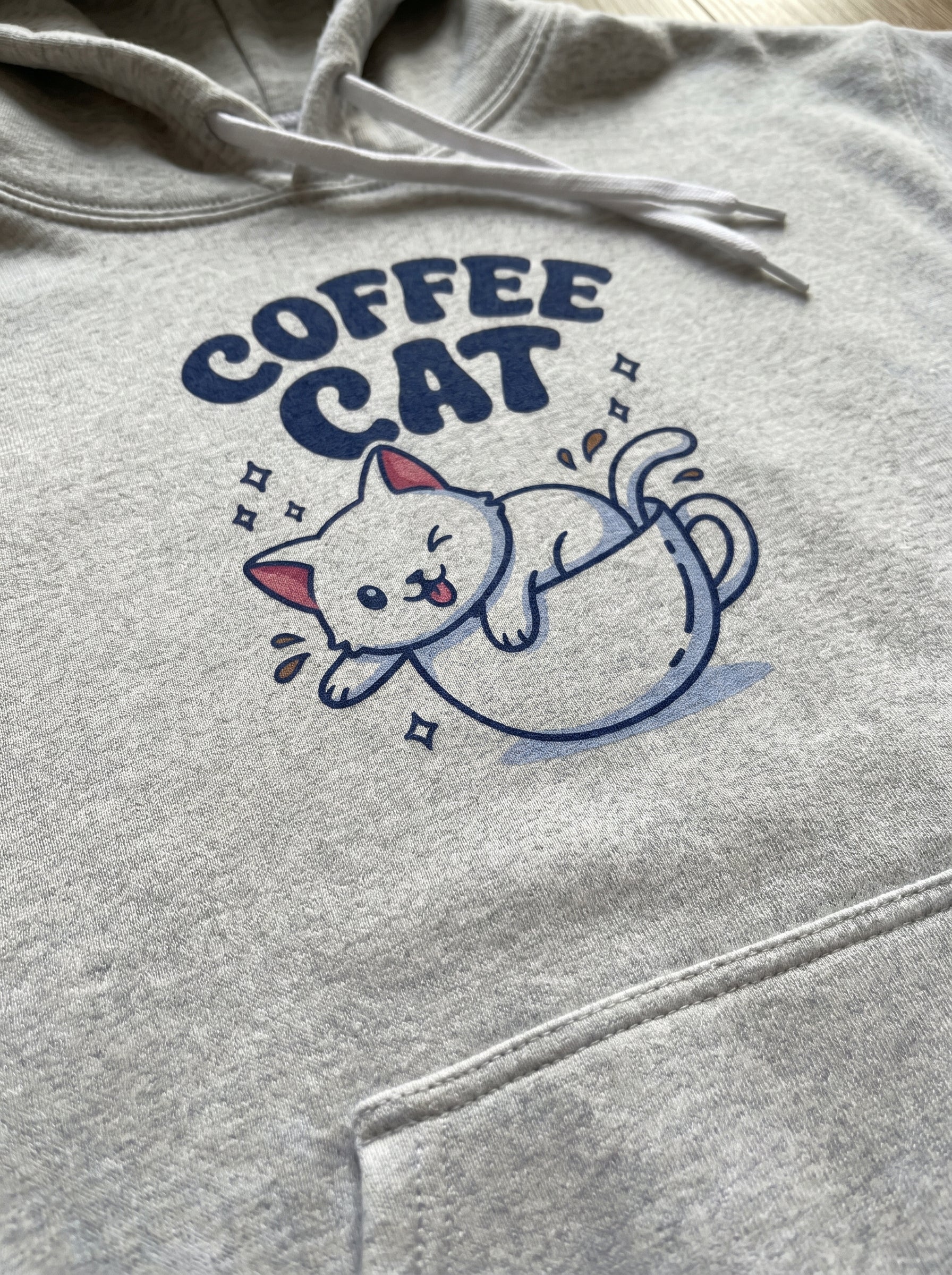 Gray hoodie with 'Coffee Cat' graphic design on a plain background